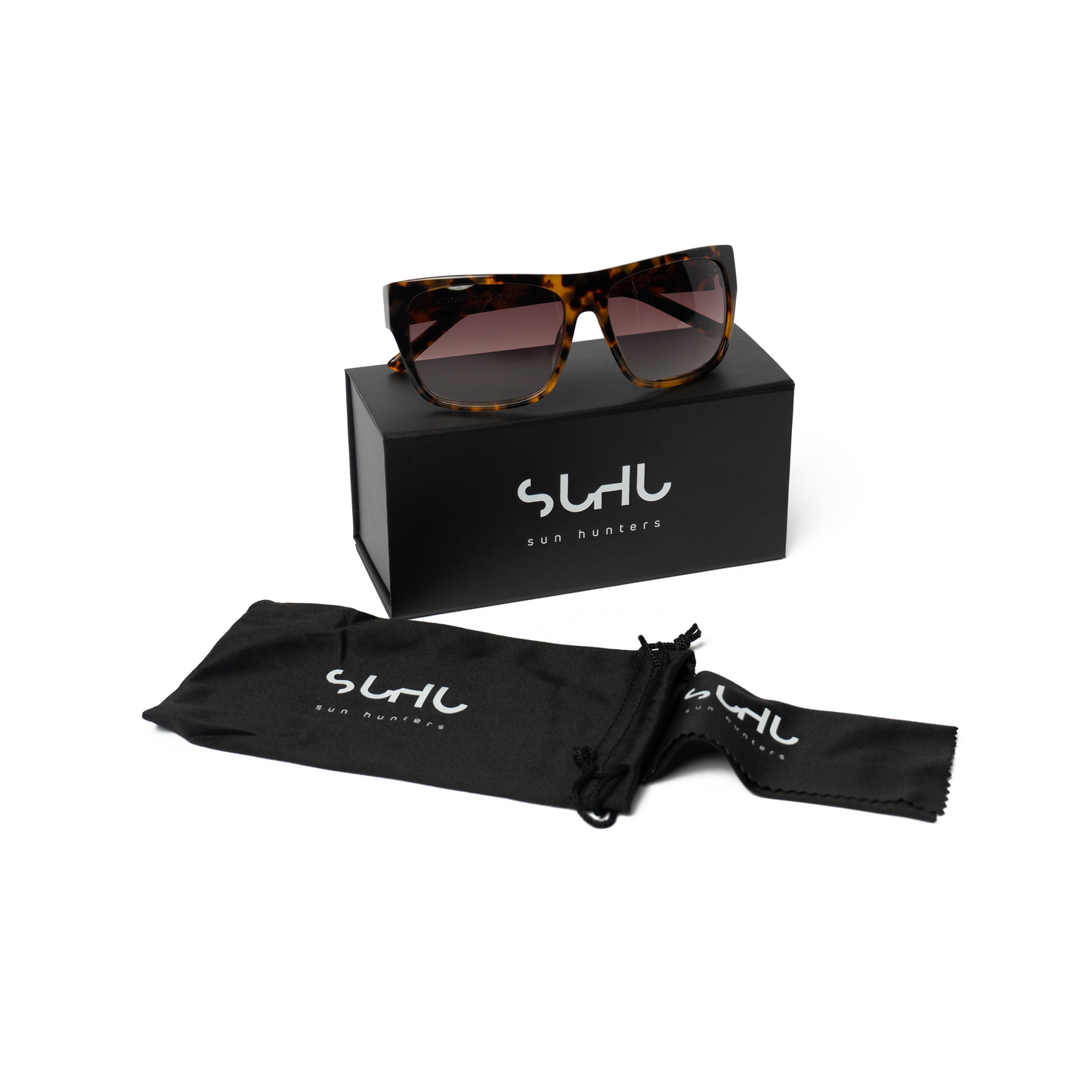 Sunglasses with a black box and pouch on a white background, featuring the brand 'Suhu'