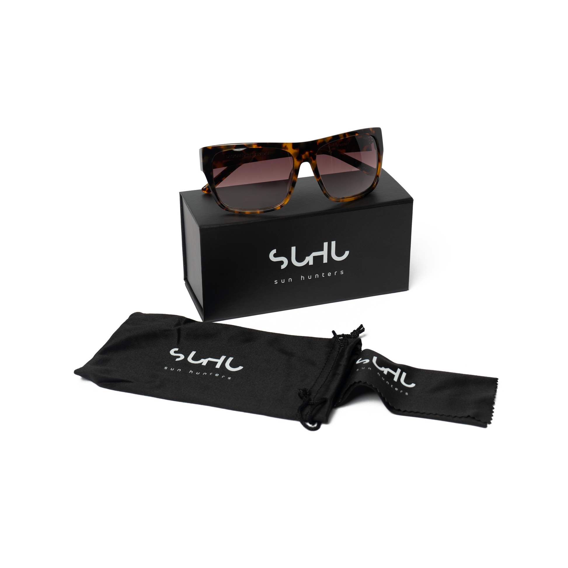 Sunglasses with a black box and pouch on a white background, featuring the brand 'Suhu'